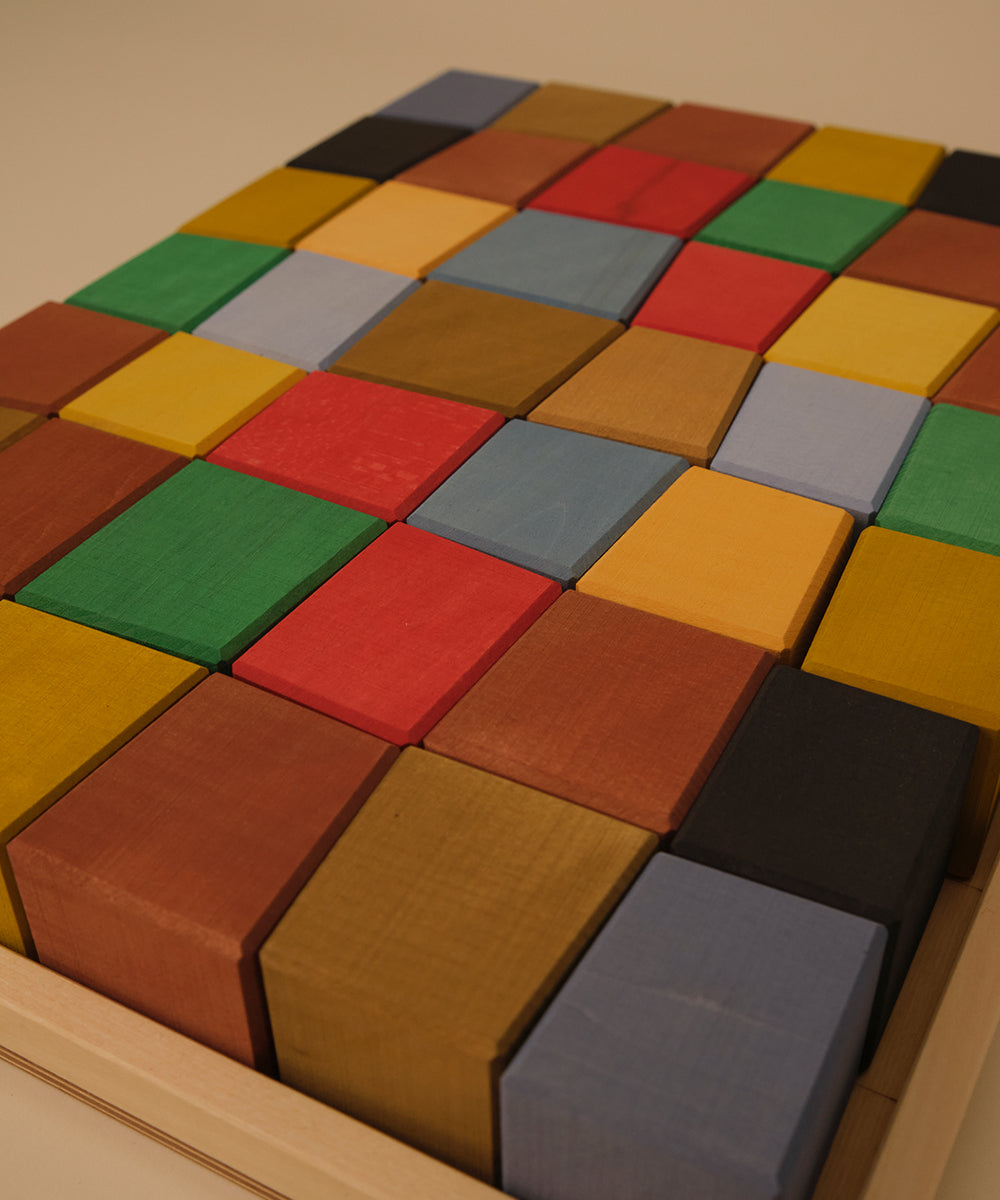 Le Oddy Cubes - Mini: Wooden tray with colorful square blocks neatly arranged in a grid pattern.