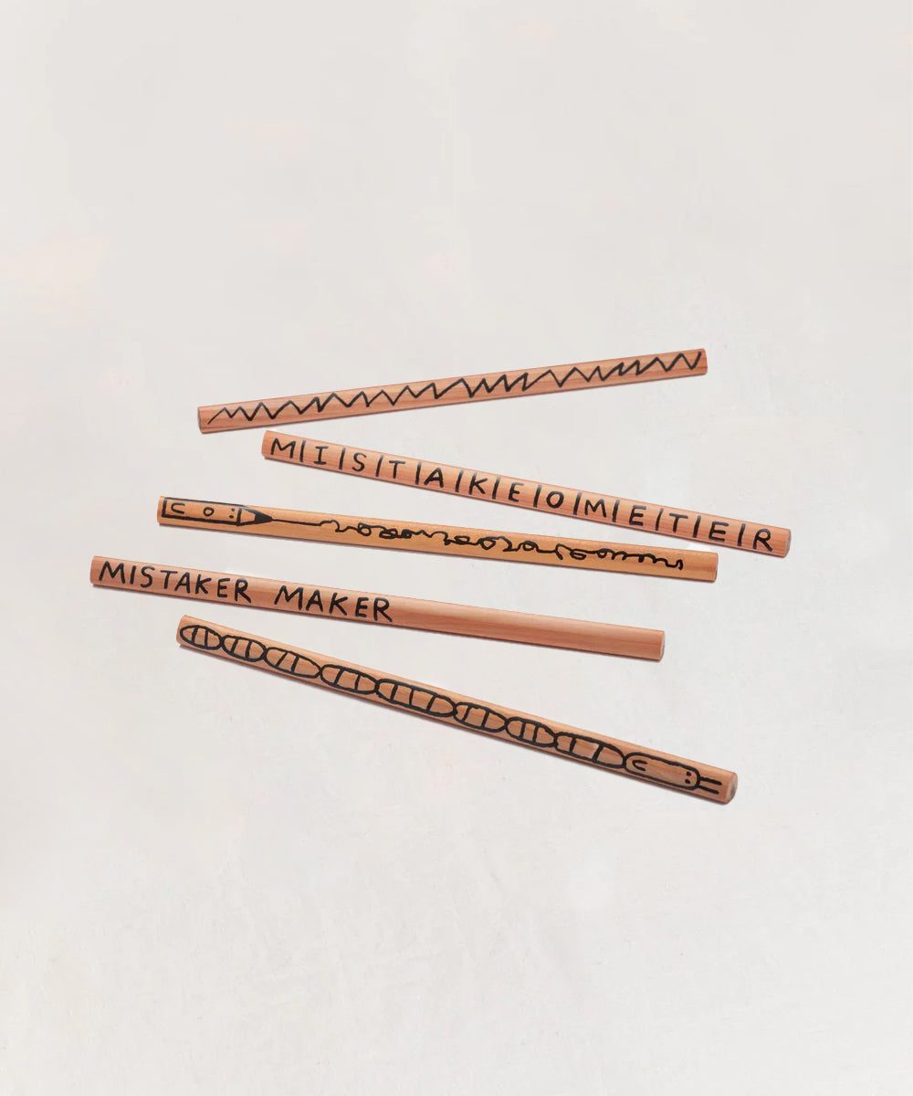 Set of five Le Mistake Maker Pencils featuring quirky black designs and text like “MISTAKOMETER” and “MISTAKER MAKER.”.