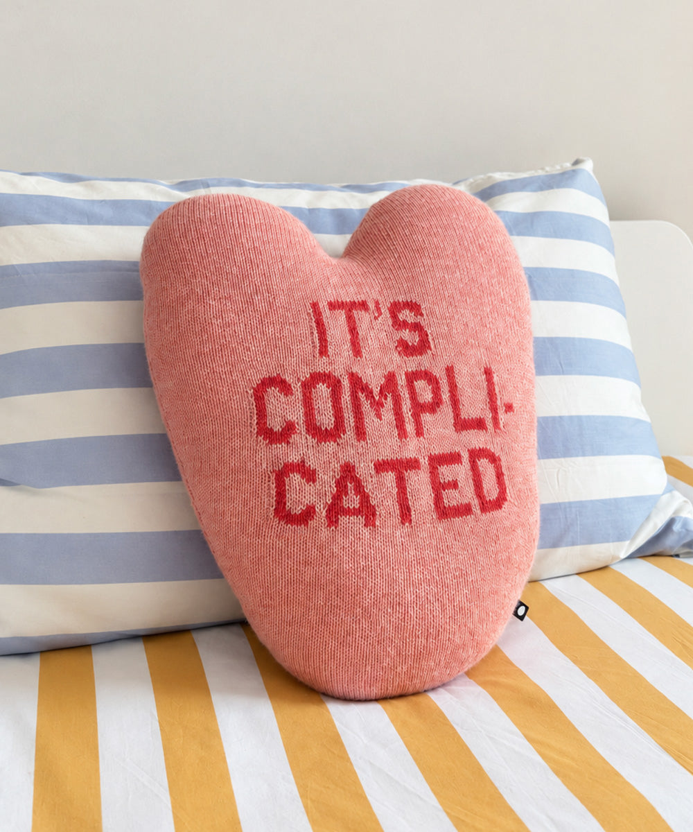 It’s Complicated Heart Pillow, a heart-shaped pink pillow with the words “IT’S COMPLICATED” in red text.