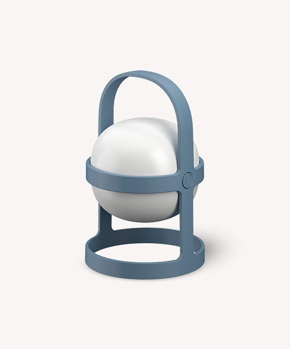 The Rosendahl Soft Spot Solar Circular in Sky Blue is a white spherical lamp with a blue circular stand and handle, resembling a modern lantern on a white background.