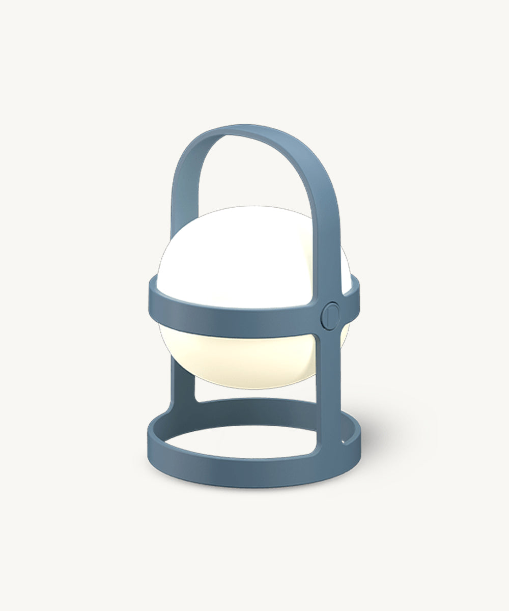 The Rosendahl Soft Spot Solar Circular in Sky Blue is a modern spherical white lamp with a blue base and handle, lantern-inspired, set on an off-white background.