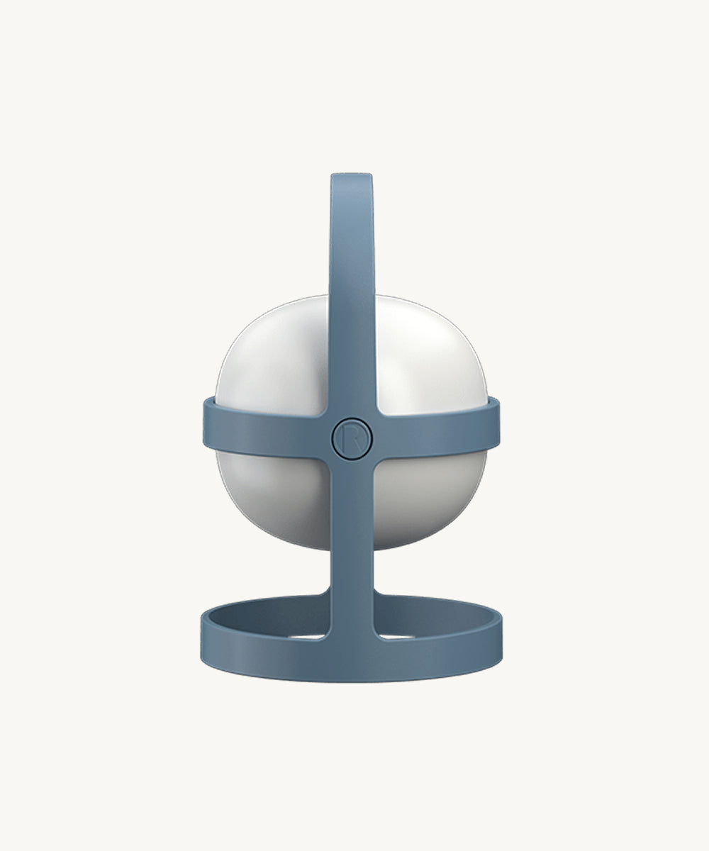 The Rosendahl Soft Spot Solar Circular in sky blue features a round white lamp held in a blue stand with a top handle, shown against a plain background.