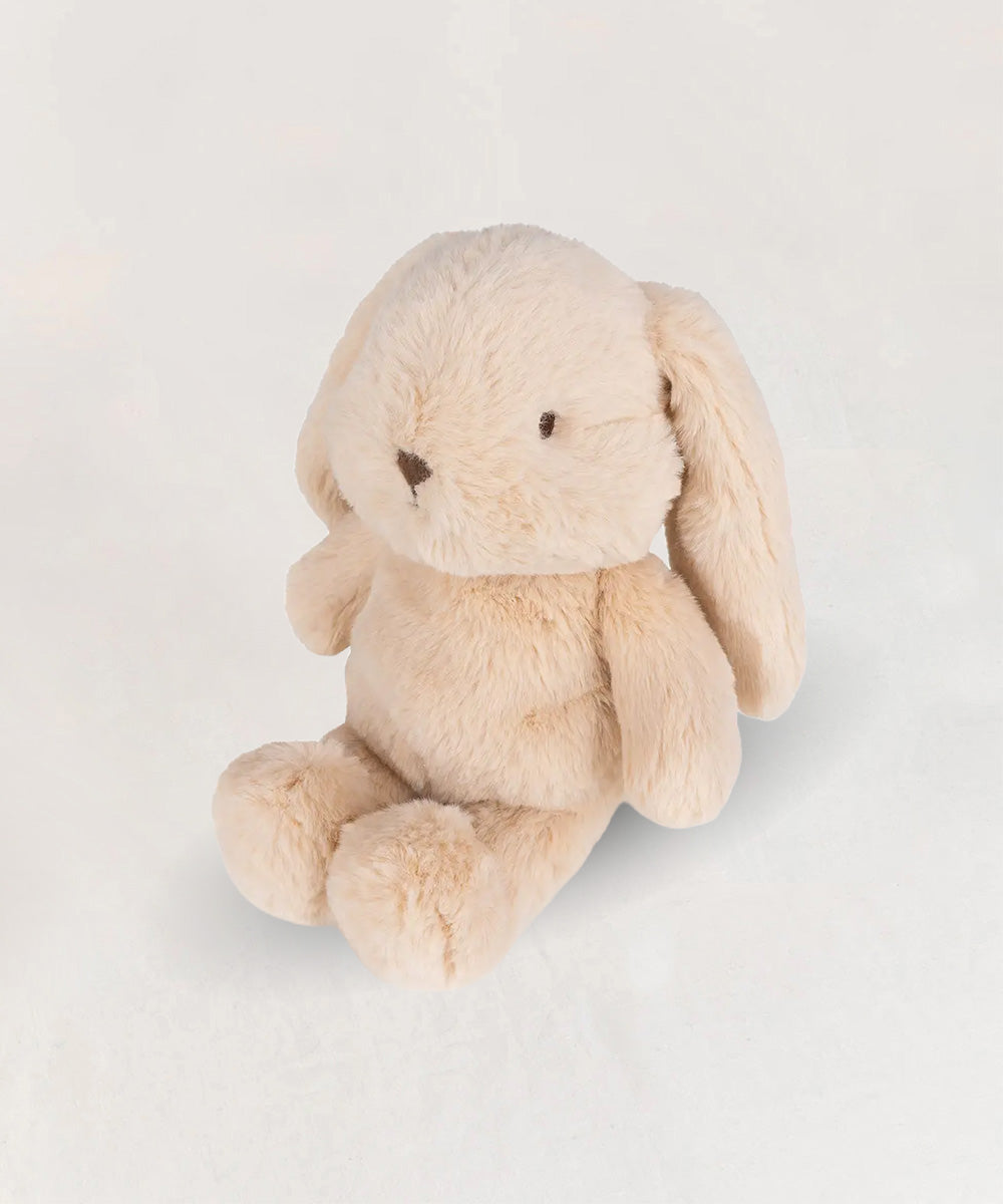 Bubbles le Bunny, a plush beige stuffed bunny with floppy ears, sits on a white background.