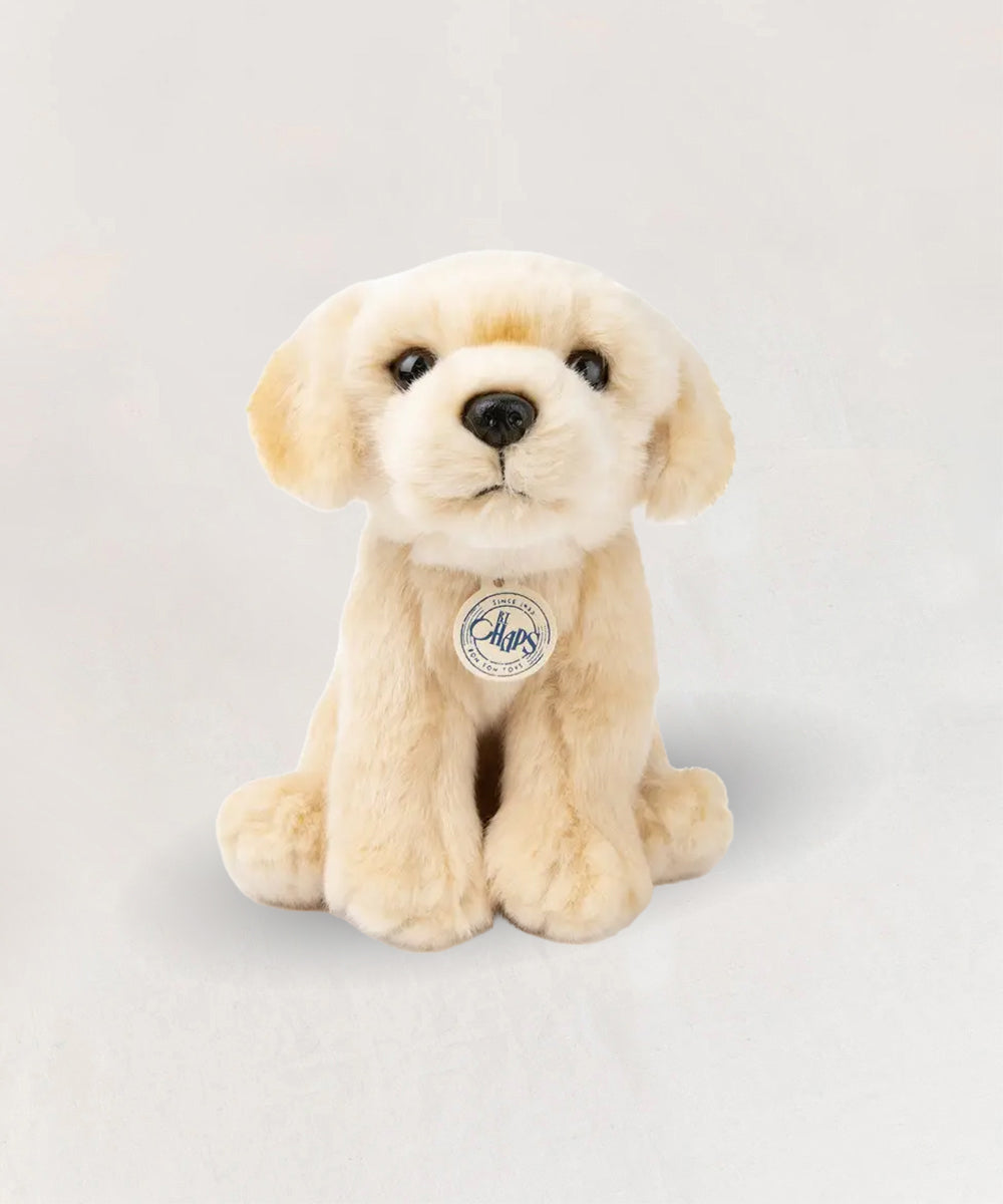 Loulou le Labrador plush toy with soft fur, sitting upright on a plain light background.