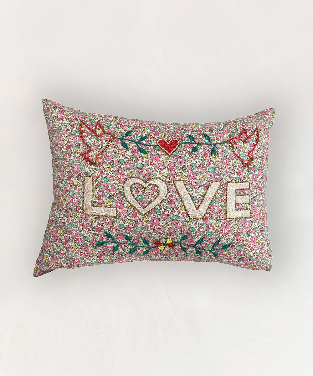 Le Embroidered Pillow - Love: Rectangular pillow featuring "LOVE" with bright, embroidered hearts and leaves.