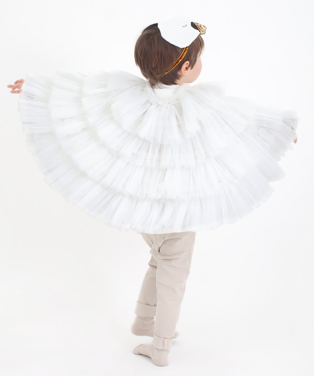 A child models the Swan Costume, featuring a white feathered cape and swan mask, shown against a white background.