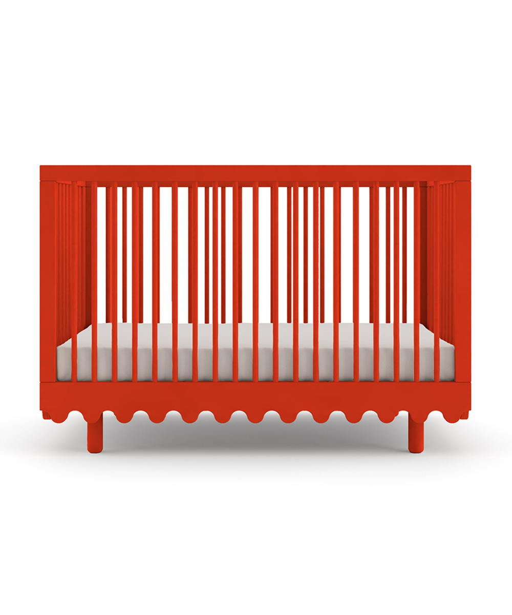 The Moss Crib is a red baby crib featuring vertical slats and a decorative scalloped bottom, set against a white background.