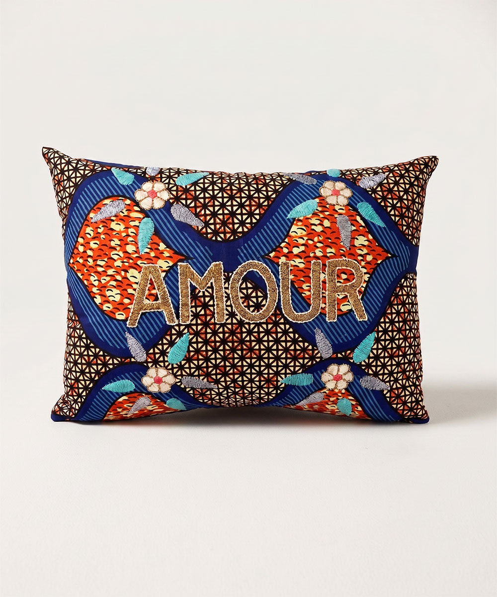 Rectangular Le Embroidered Pillow - Sun Print Amour with colorful geometric patterns and "AMOUR" embroidered in gold on the front.