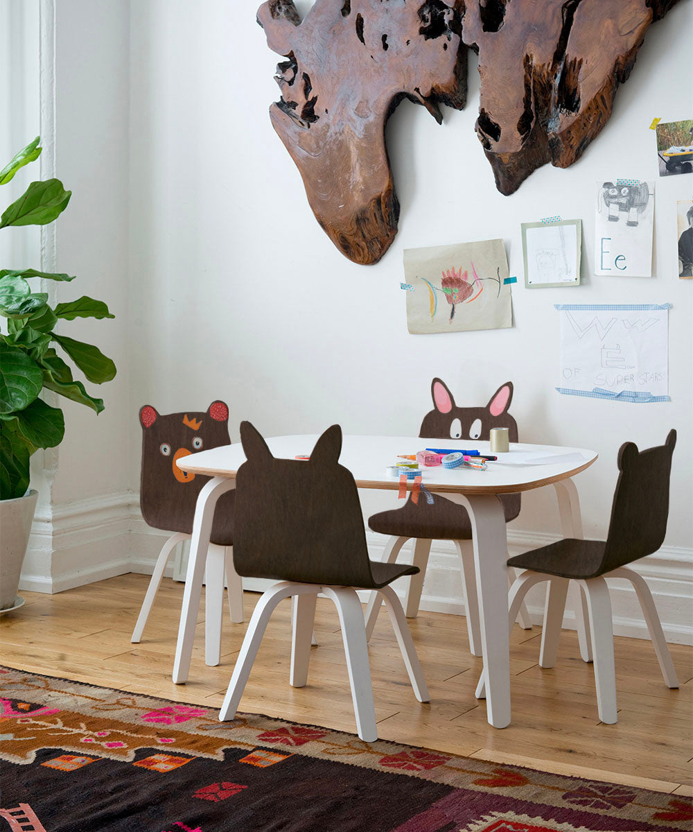 Four Bunny Play Chair (Set of 2) children’s chairs with animal-shaped backrests arranged around a small white table.