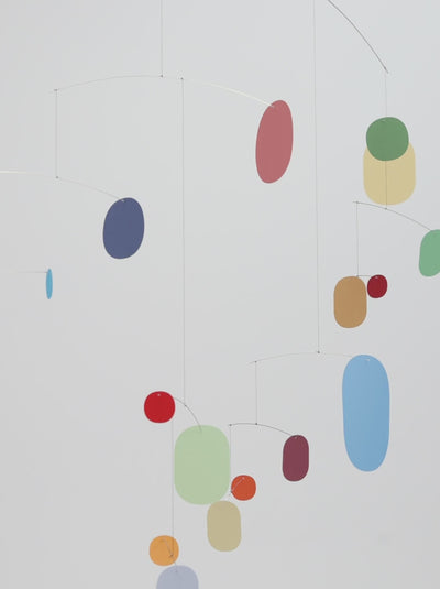 video of a mid-century colorful mobile slowing turning in empty space