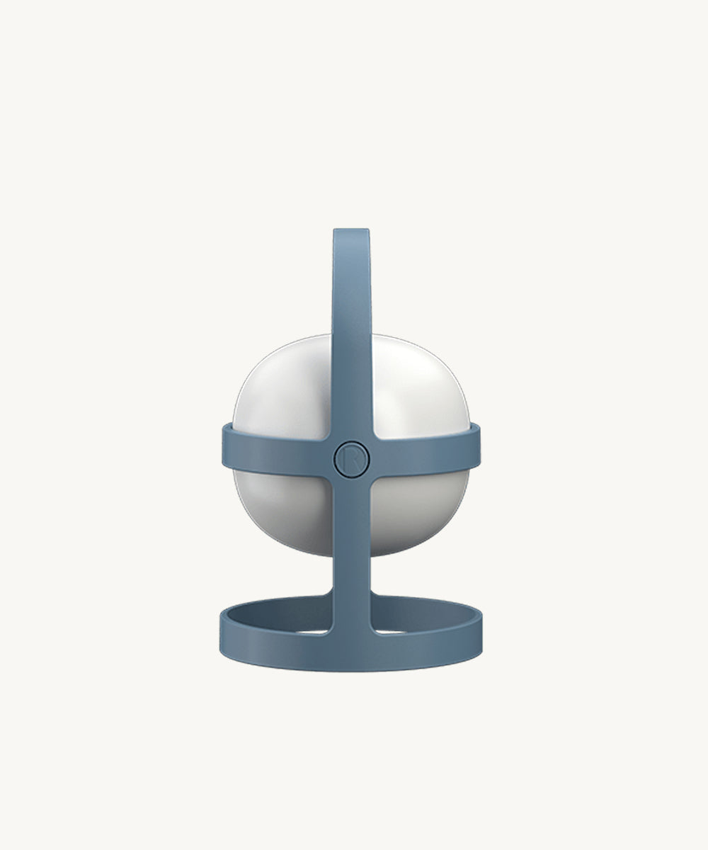 The Rosendahl Soft Spot Solar Circular in Sky Blue sits in its handle-equipped stand, pictured against a plain white background.