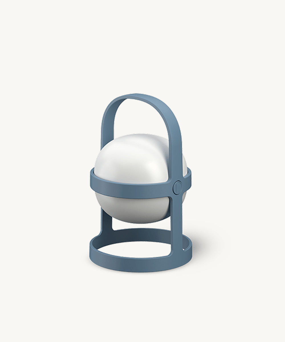 The Rosendahl Soft Spot Solar Circular in Sky Blue is a round white lamp with a blue circular frame and handle, resembling a modern lantern, shown on a plain white background.
