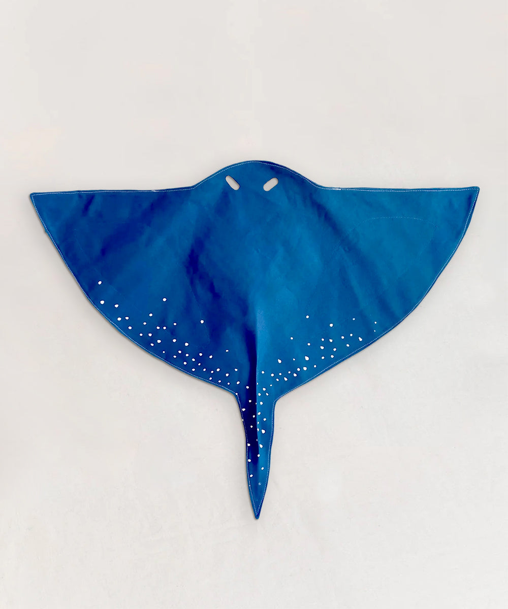 Le Stingray Costume Wings are blue manta ray-shaped fabric with white spots and two cut-out eye holes, shown on a light background.