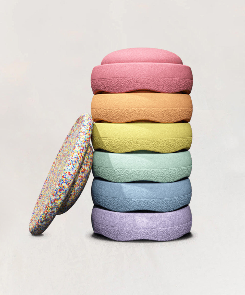 Le Stepping Stones - Rainbow Set: six colorful textured discs, including one sprinkled, stacked together on a plain background.