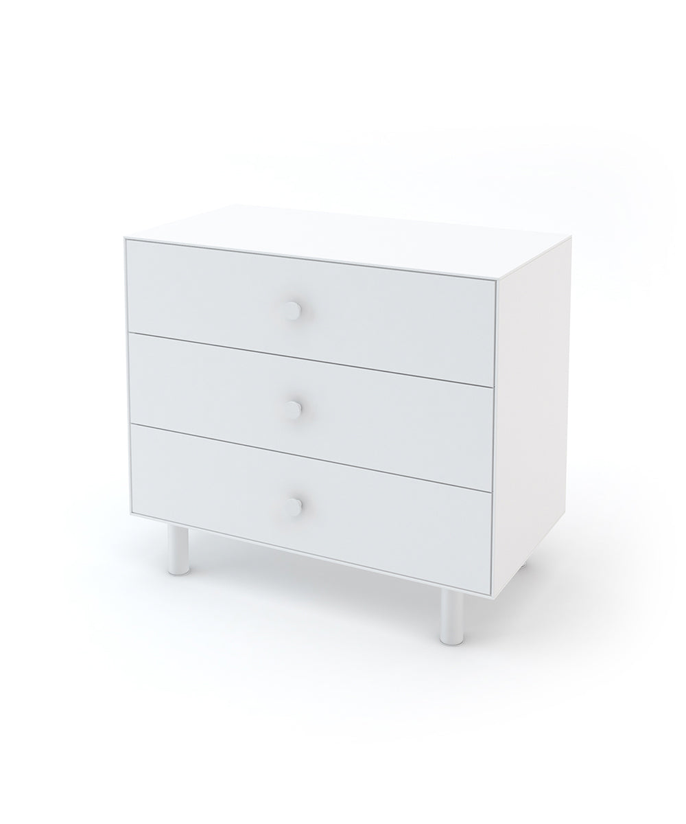 All-white dresser with three drawers, metal knobs and legs. 