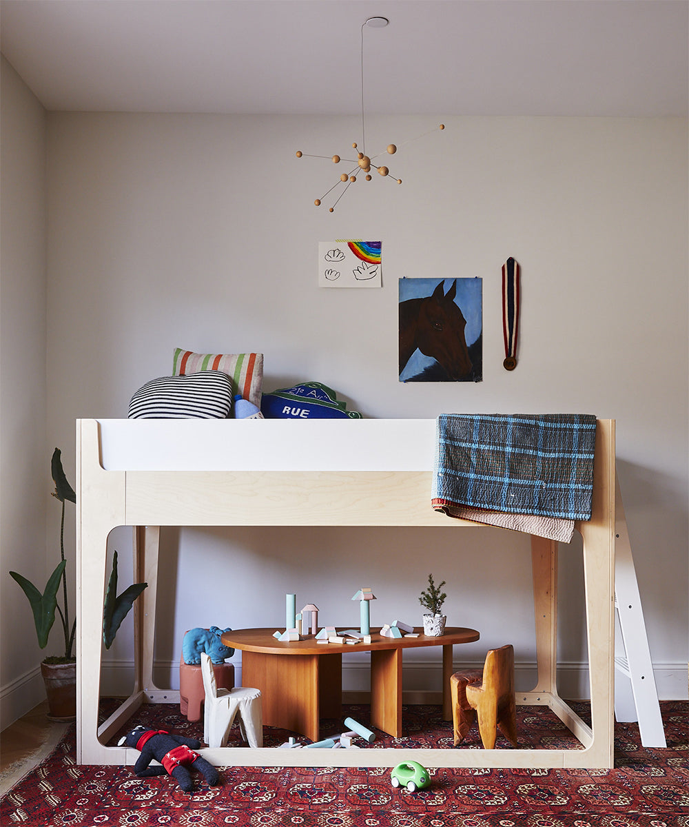 photo of Nest loft bed with a small table and chair under the loft